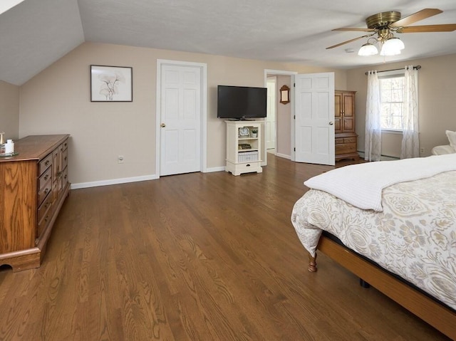 bedroom with a baseboard heating unit, baseboards, ceiling fan, lofted ceiling, and dark wood-style floors