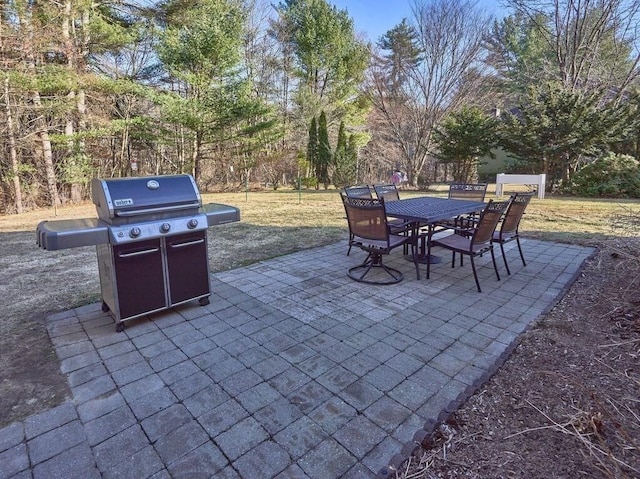 view of patio with outdoor dining area and a grill