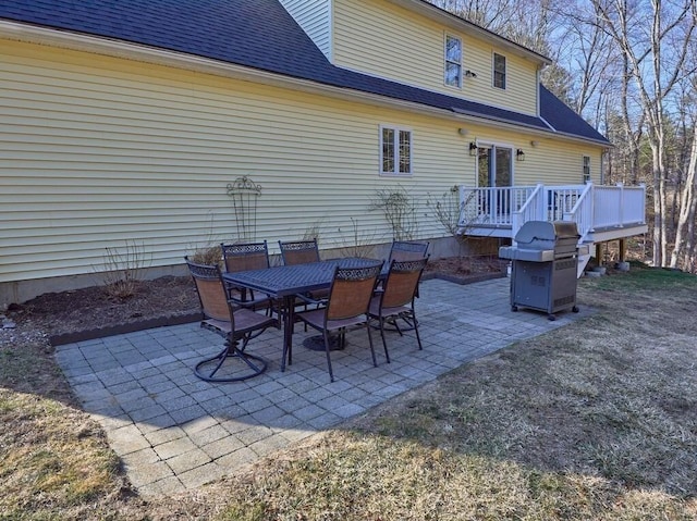 view of patio featuring area for grilling, outdoor dining area, and a deck