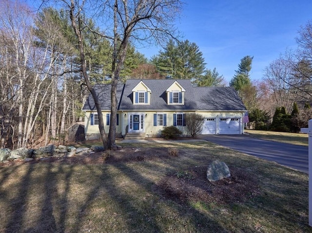 new england style home with a garage and driveway