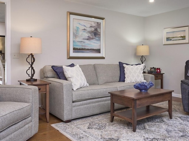 living room featuring recessed lighting, baseboards, and wood finished floors