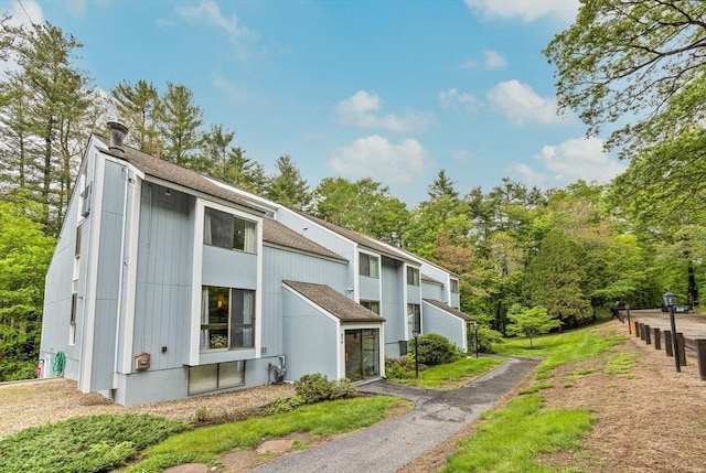 374 Great Rd Unit 10, Acton, MA 01720 - view of home's exterior featuring roof with shingles
