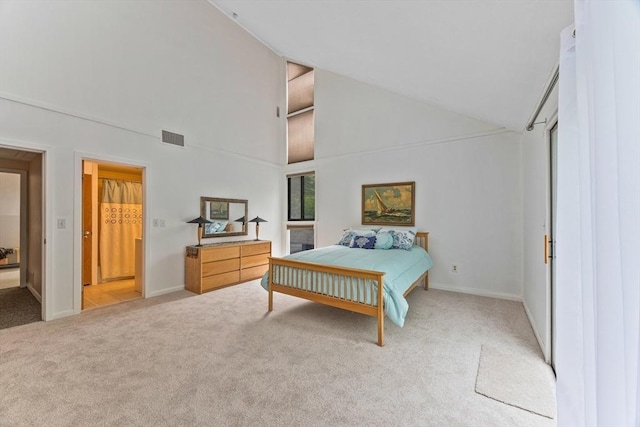374 Great Rd Unit 10, Acton, MA 01720 - bedroom with light colored carpet, high vaulted ceiling, and baseboards