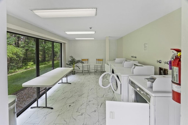 374 Great Rd Unit 10, Acton, MA 01720 - shared laundry featuring light marble finish flooring and washing machine and dryer