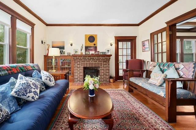 living room featuring wood finished floors, a fireplace, and ornamental molding