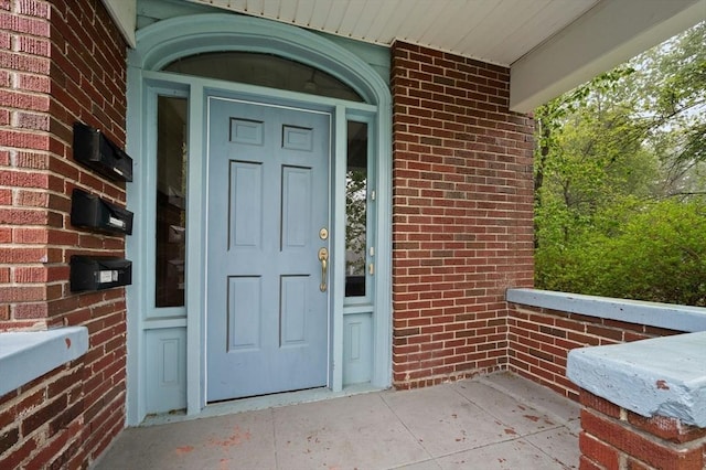 entrance to property with brick siding