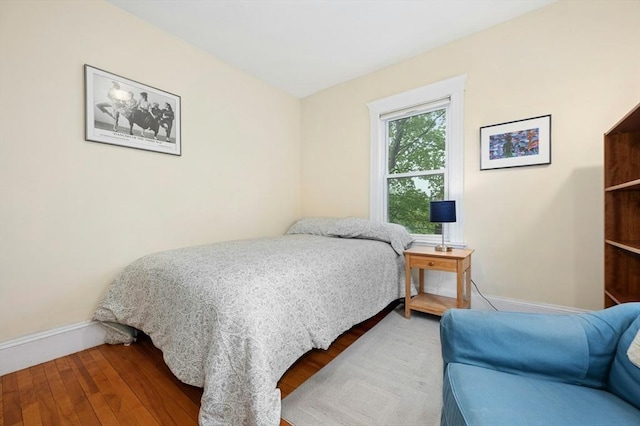 bedroom featuring baseboards and wood finished floors