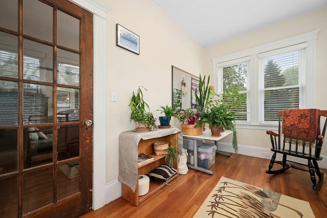 living area with wood finished floors and baseboards