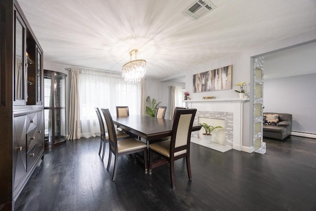 109 Circle Dr, Wrentham, MA 02093 - dining room with dark wood finished floors, a chandelier, a baseboard radiator, and a fireplace with flush hearth