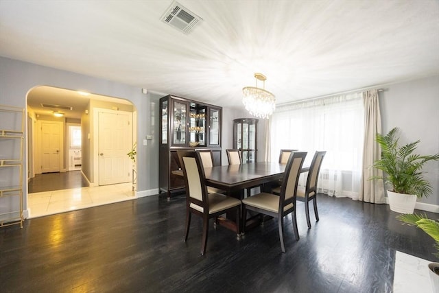 109 Circle Dr, Wrentham, MA 02093 - dining area with arched walkways, dark wood-type flooring, and a chandelier
