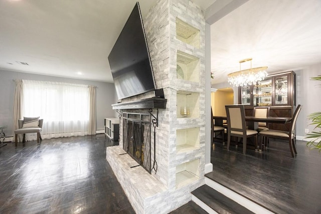 109 Circle Dr, Wrentham, MA 02093 - living room with dark wood finished floors, a fireplace, and a chandelier