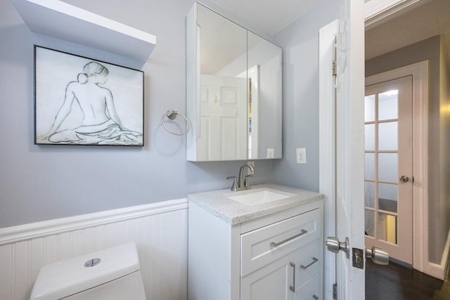 109 Circle Dr, Wrentham, MA 02093 - bathroom with vanity, a wainscoted wall, and wood finished floors