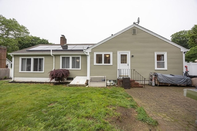 109 Circle Dr, Wrentham, MA 02093 - rear view of house featuring solar panels, entry steps, a chimney, and a patio