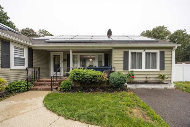 109 Circle Dr, Wrentham, MA 02093 - view of front of house with a porch, solar panels, and roof with shingles