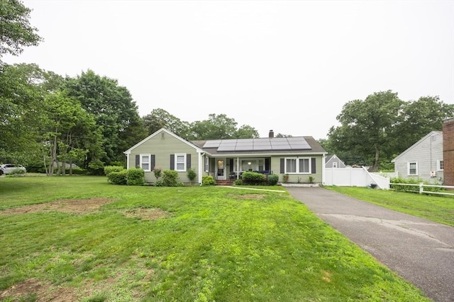 109 Circle Dr, Wrentham, MA 02093 - view of front of house with roof mounted solar panels, a porch, a chimney, and driveway