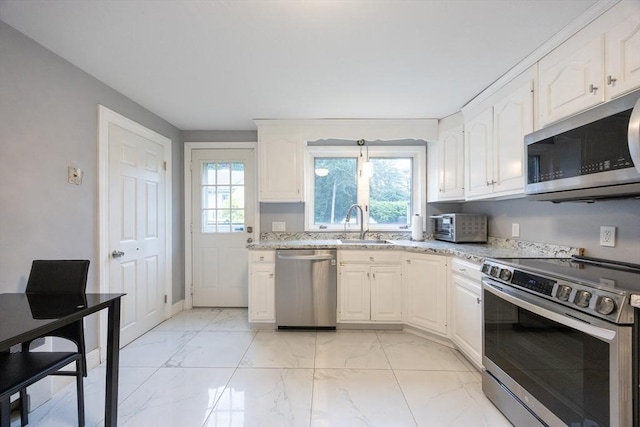109 Circle Dr, Wrentham, MA 02093 - kitchen with stainless steel appliances, light marble finish floors, light stone counters, and white cabinetry
