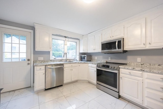 109 Circle Dr, Wrentham, MA 02093 - kitchen featuring stainless steel appliances, light marble finish flooring, and healthy amount of natural light