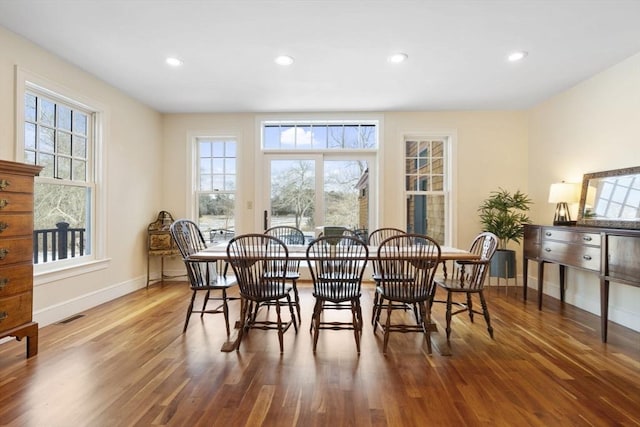 dining space featuring baseboards, recessed lighting, wood finished floors, and visible vents
