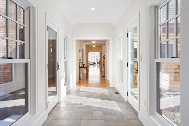 corridor with vaulted ceiling