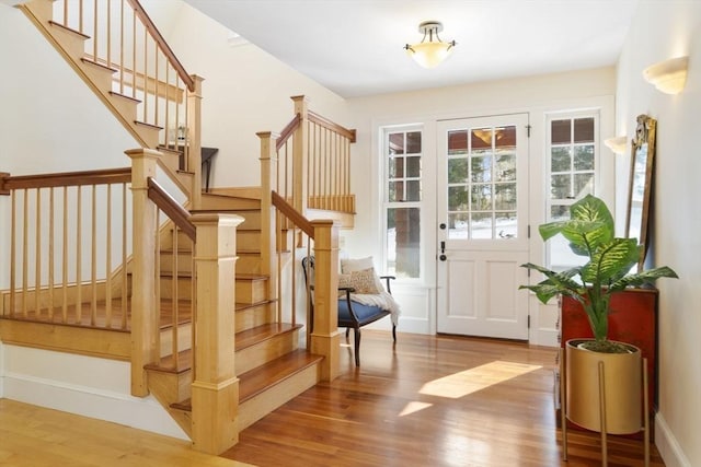 doorway featuring stairs and wood finished floors