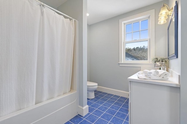 full bath featuring shower / bath combo, tile patterned flooring, vanity, toilet, and baseboards