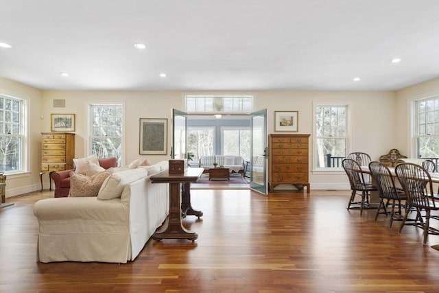living room with recessed lighting, baseboards, and wood finished floors