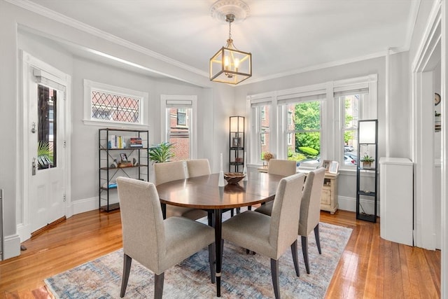 17 Park Vale Unit 2, Brookline, MA 02446 - dining area featuring light wood finished floors, a chandelier, baseboards, and crown molding