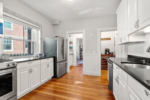 17 Park Vale Unit 2, Brookline, MA 02446 - kitchen with stainless steel appliances, a sink, light wood finished floors, and backsplash
