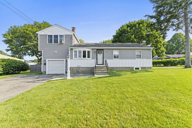 36 Porter Rd, Marlborough, MA 01752 - view of front facade with a chimney, driveway, a garage, and a front lawn