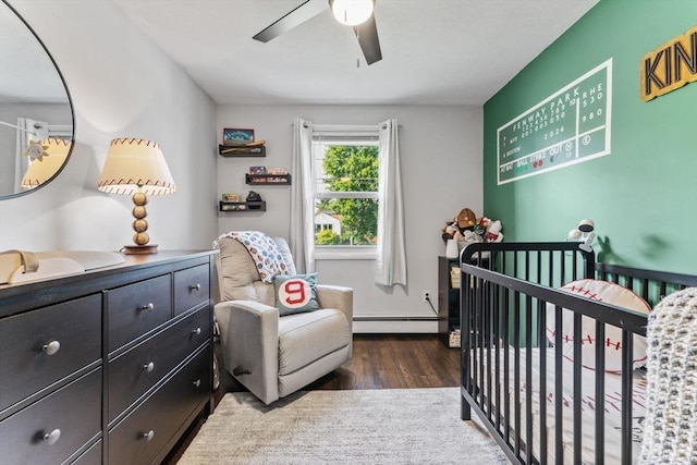 36 Porter Rd, Marlborough, MA 01752 - bedroom featuring baseboard heating, wood finished floors, a nursery area, and a ceiling fan
