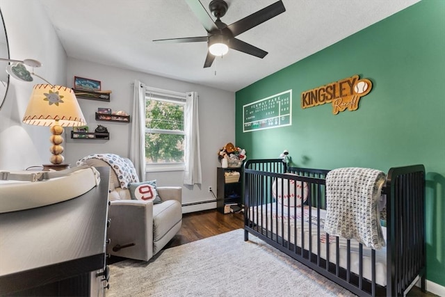 36 Porter Rd, Marlborough, MA 01752 - bedroom with a nursery area, wood finished floors, ceiling fan, and a baseboard radiator