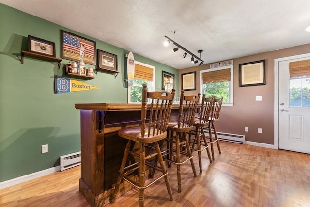36 Porter Rd, Marlborough, MA 01752 - indoor dry bar with a baseboard heating unit, a baseboard radiator, wood finished floors, and plenty of natural light