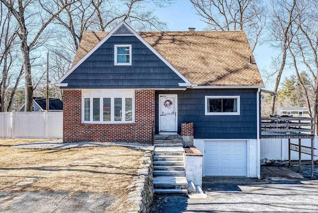 view of front of property with brick siding, fence, roof with shingles, a chimney, and an attached garage