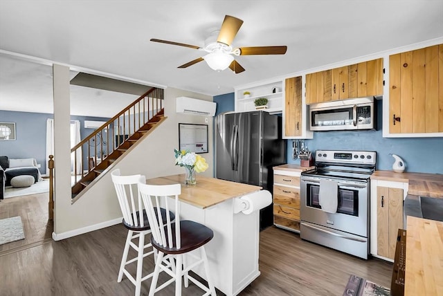 kitchen with stainless steel appliances, butcher block countertops, dark wood finished floors, and an AC wall unit