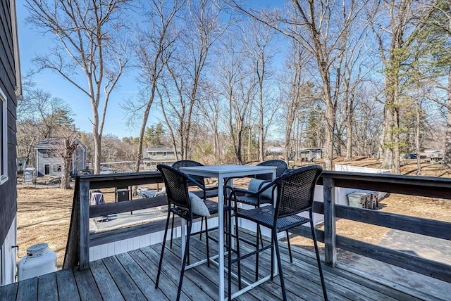 wooden terrace with outdoor dining area