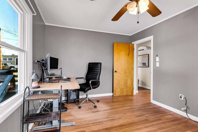 home office with baseboards, wood finished floors, a ceiling fan, and ornamental molding