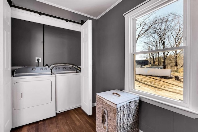 laundry room featuring dark wood finished floors, laundry area, washing machine and dryer, and ornamental molding