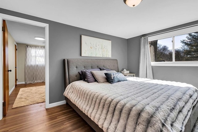 bedroom featuring baseboards and wood finished floors