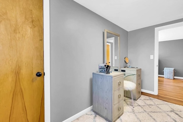 bathroom featuring baseboards and wood finished floors