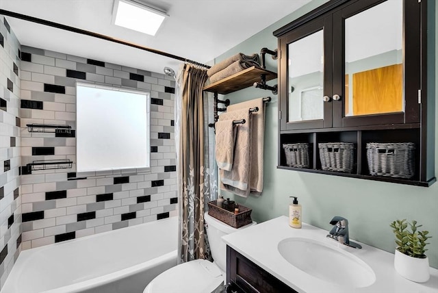 bathroom with shower / bath combo with shower curtain, toilet, and vanity