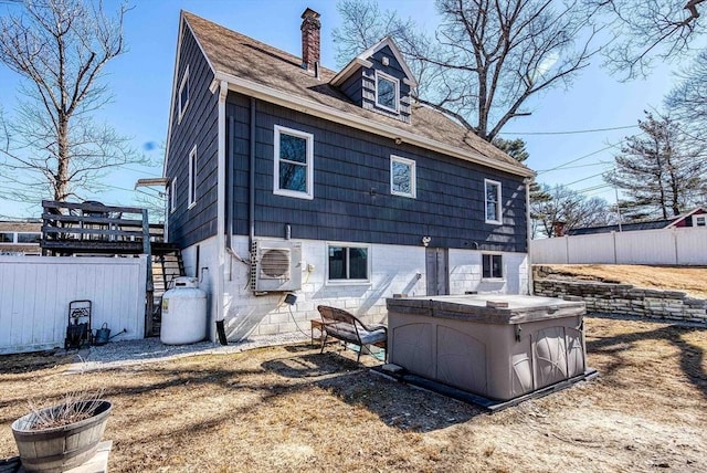 back of house featuring ac unit, a chimney, stairs, and fence