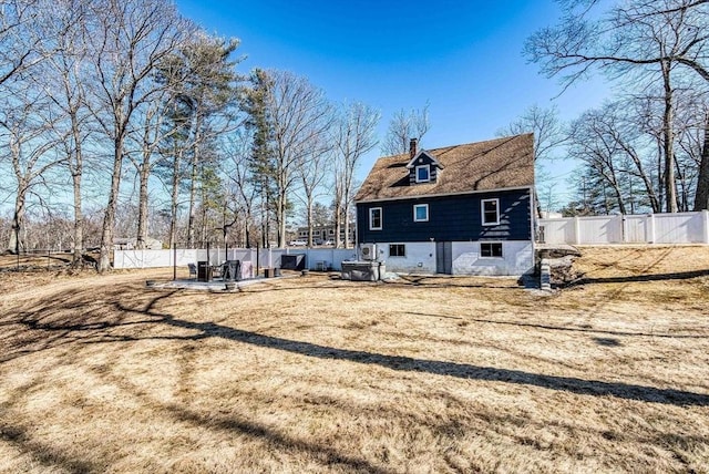 view of property exterior featuring a patio, a chimney, and a fenced backyard