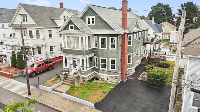 67-69 Nesmith St, Lawrence, MA 01841 - view of front of property featuring asphalt driveway, a chimney, and a residential view