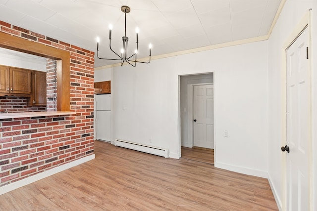 67-69 Nesmith St, Lawrence, MA 01841 - unfurnished dining area with baseboard heating, a chandelier, and light wood-style floors