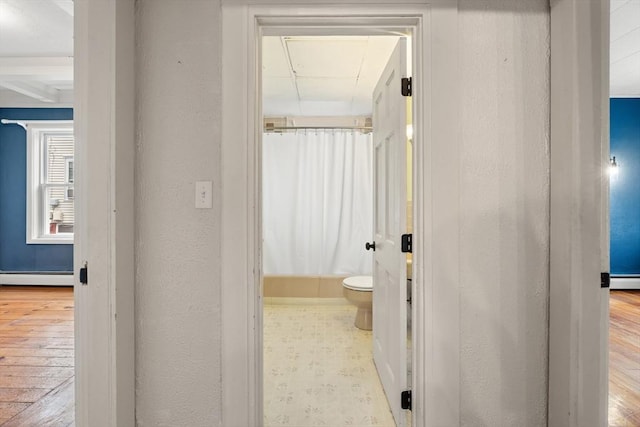 67-69 Nesmith St, Lawrence, MA 01841 - hallway featuring baseboard heating, hardwood / wood-style floors, and a textured wall