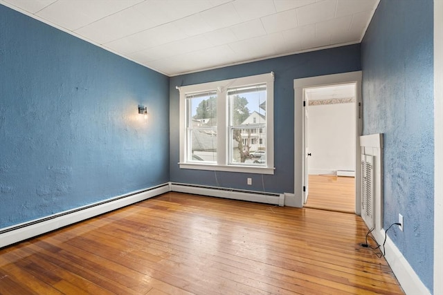 67-69 Nesmith St, Lawrence, MA 01841 - unfurnished room featuring wood-type flooring, a baseboard heating unit, crown molding, and a textured wall