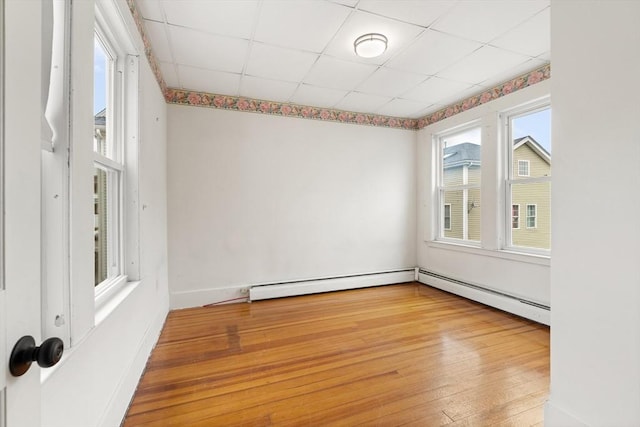 67-69 Nesmith St, Lawrence, MA 01841 - spare room featuring light wood finished floors, a baseboard radiator, and a drop ceiling