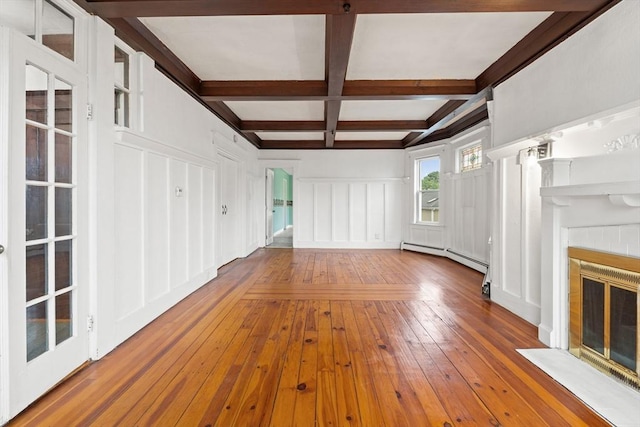 67-69 Nesmith St, Lawrence, MA 01841 - unfurnished living room featuring a decorative wall, a baseboard radiator, a fireplace with flush hearth, coffered ceiling, and beam ceiling
