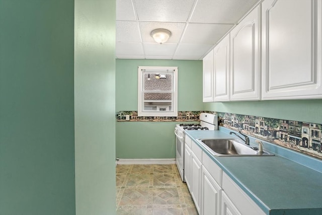 67-69 Nesmith St, Lawrence, MA 01841 - kitchen with white gas range oven, white cabinets, and a paneled ceiling