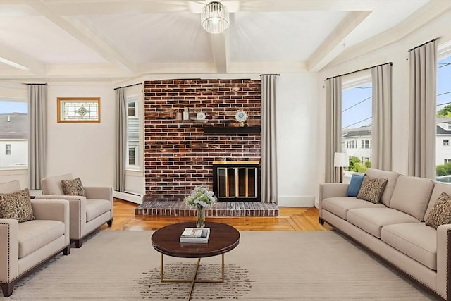 67-69 Nesmith St, Lawrence, MA 01841 - living room with beamed ceiling, healthy amount of natural light, a brick fireplace, and wood finished floors